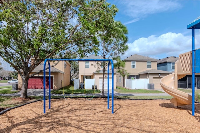 community playground featuring a residential view, central AC, and fence