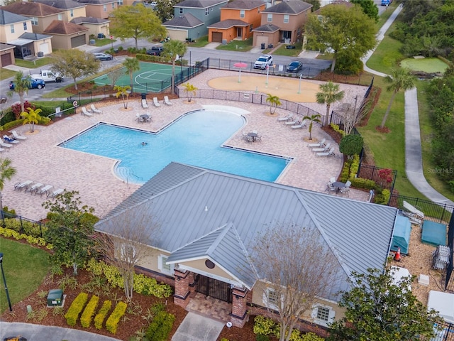 pool featuring a patio area, fence, and a residential view