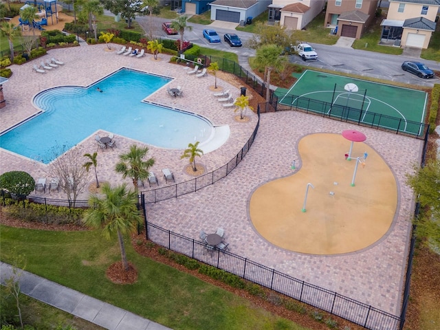 view of swimming pool featuring fence