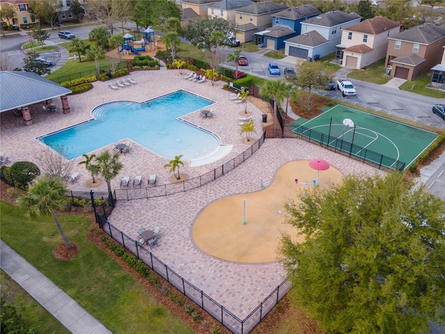 view of swimming pool with a residential view and fence