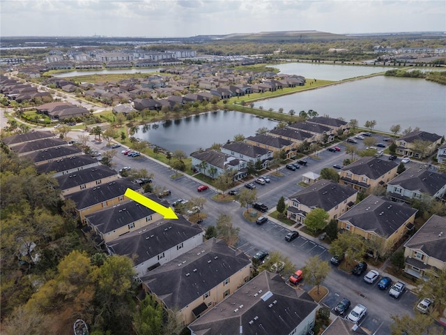 birds eye view of property featuring a water view and a residential view