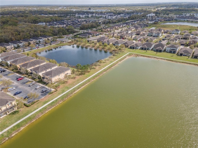 birds eye view of property with a water view and a residential view