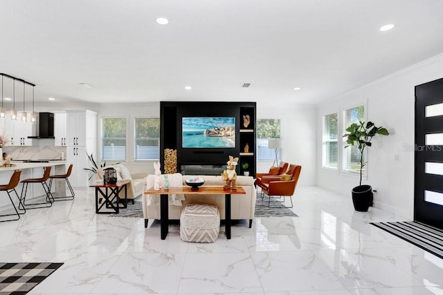 living room featuring crown molding, marble finish floor, plenty of natural light, and recessed lighting