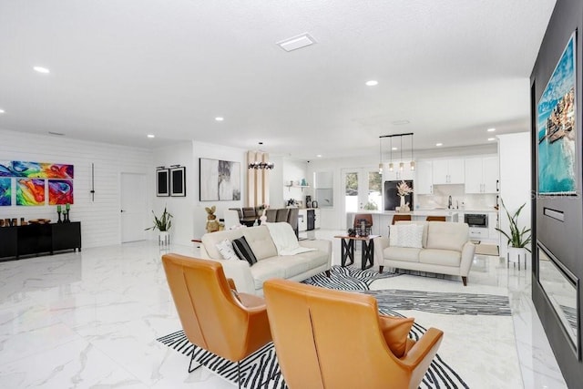 living area with marble finish floor, visible vents, and recessed lighting