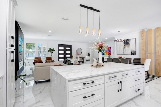 kitchen with pendant lighting, marble finish floor, recessed lighting, visible vents, and a kitchen island