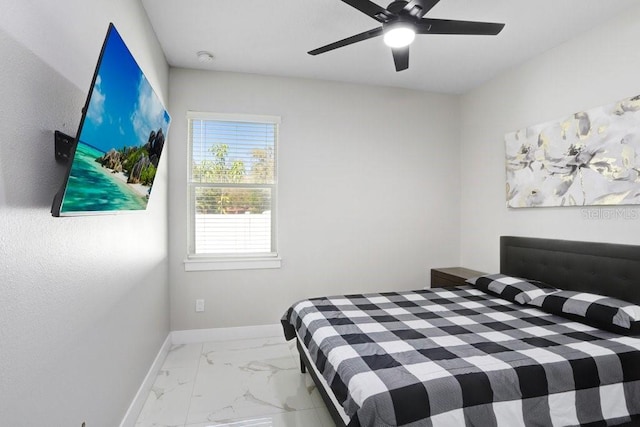 bedroom featuring marble finish floor, baseboards, and a ceiling fan