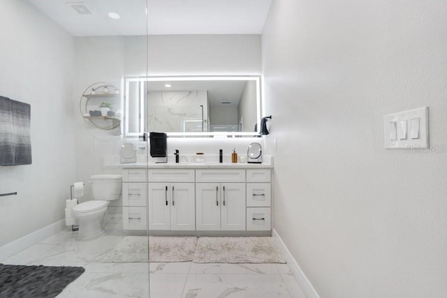 bathroom featuring marble finish floor, baseboards, and toilet