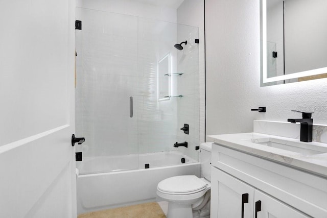 full bathroom with a textured wall, shower / bathing tub combination, vanity, and toilet