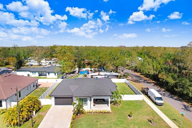 drone / aerial view featuring a forest view and a residential view