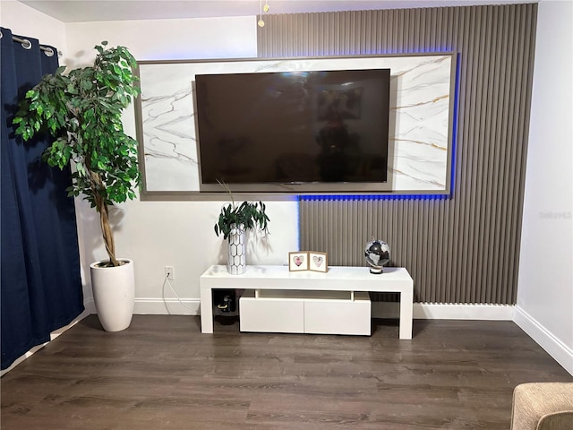 sitting room featuring baseboards and wood finished floors