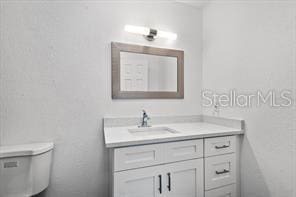 bathroom with toilet and vanity