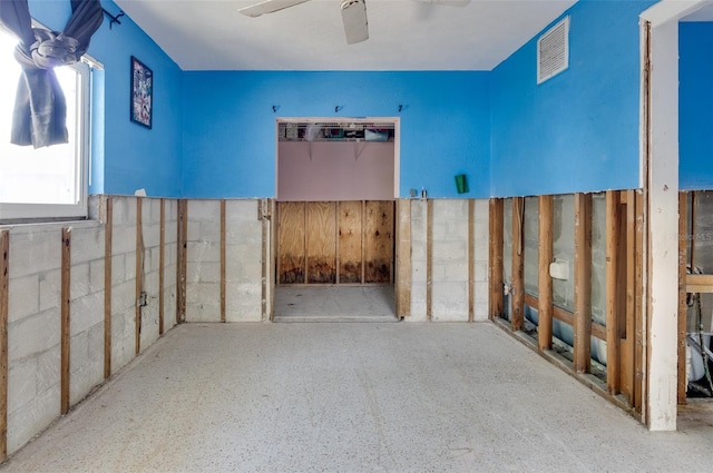 interior space featuring visible vents and ceiling fan