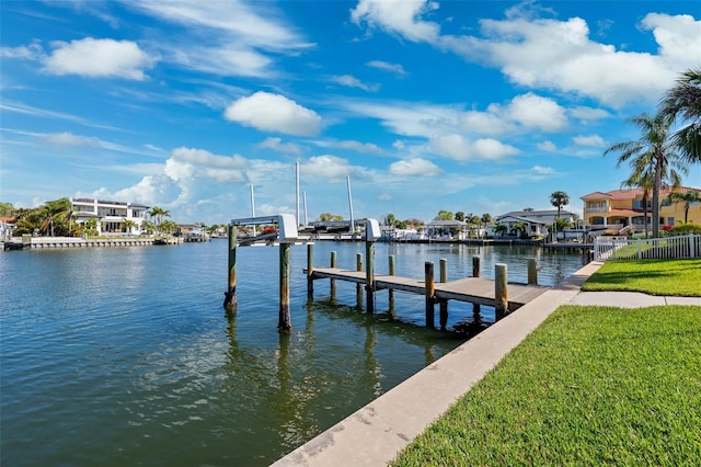 dock area featuring a yard, a water view, and boat lift