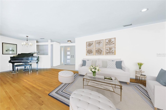 living room featuring a notable chandelier, light wood finished floors, recessed lighting, visible vents, and baseboards