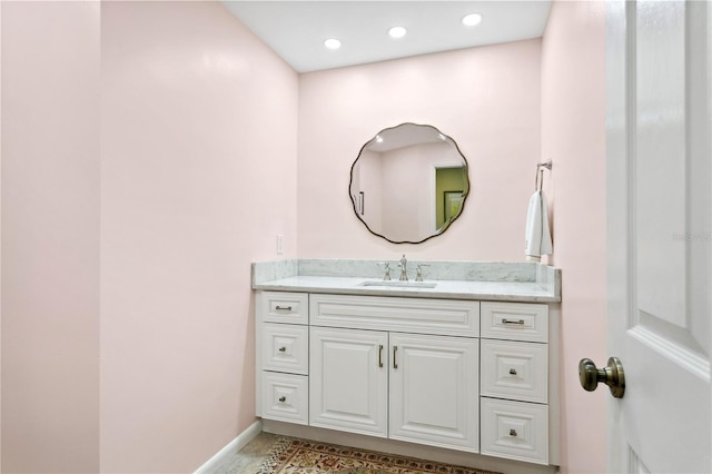 bathroom featuring recessed lighting, vanity, and baseboards