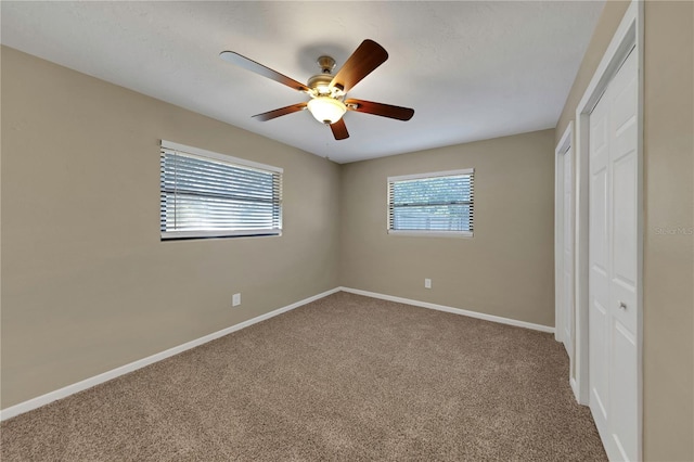 unfurnished bedroom with a ceiling fan, baseboards, and carpet floors