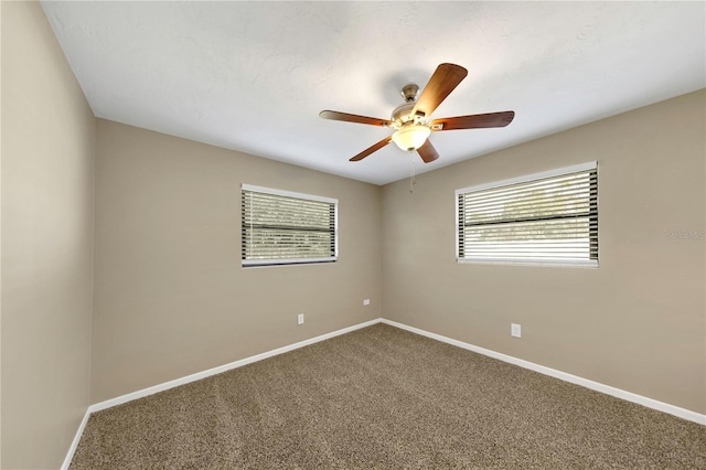 spare room featuring baseboards, carpet floors, and ceiling fan