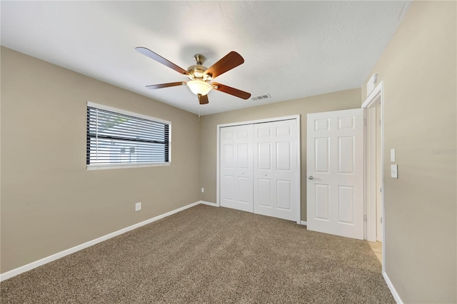 unfurnished bedroom with a closet, visible vents, baseboards, and carpet floors