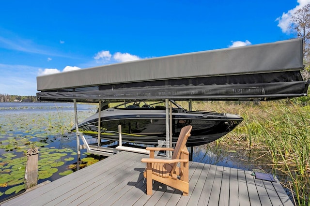 view of dock with a water view and boat lift