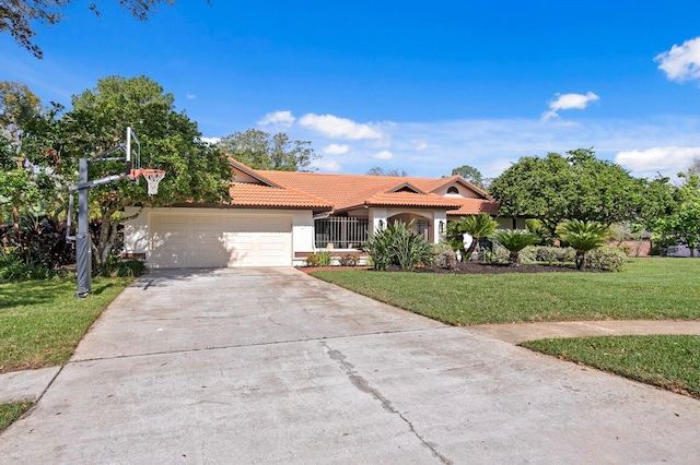 mediterranean / spanish home with driveway, a garage, a tile roof, a front lawn, and stucco siding