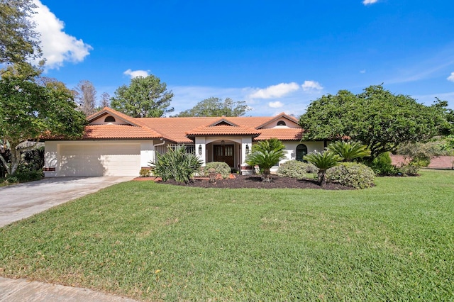 mediterranean / spanish-style home with a garage, driveway, a front lawn, and a tile roof