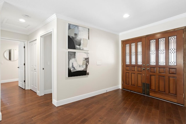 foyer entrance with dark wood-type flooring, crown molding, and baseboards