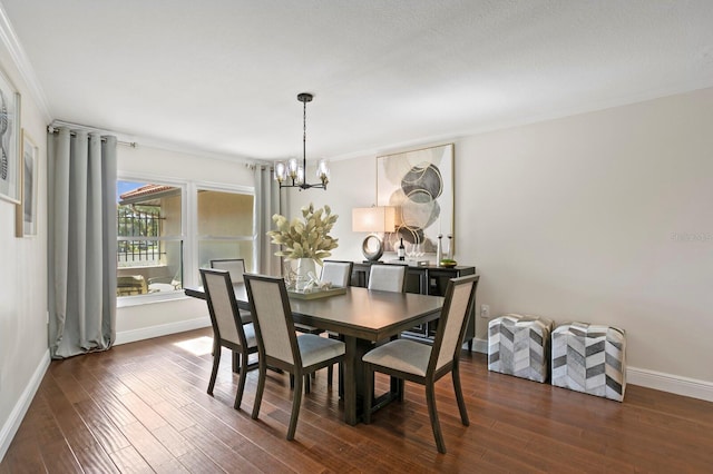 dining room featuring baseboards, ornamental molding, dark wood-style flooring, and an inviting chandelier