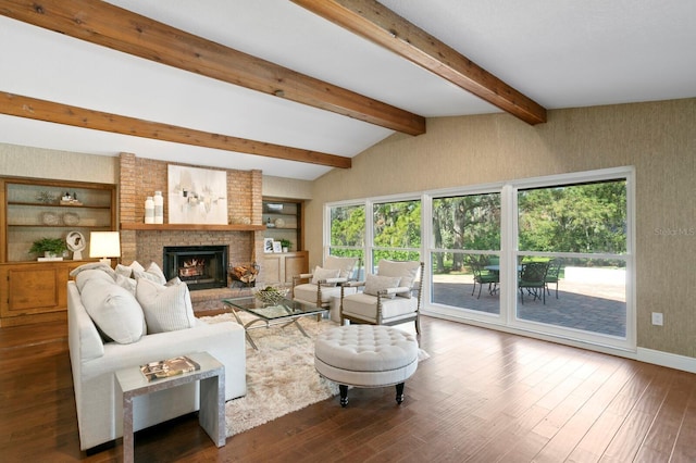 living area with a fireplace, vaulted ceiling with beams, baseboards, and wood finished floors