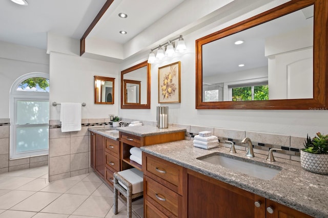 bathroom with a wainscoted wall, tile walls, recessed lighting, vanity, and tile patterned floors