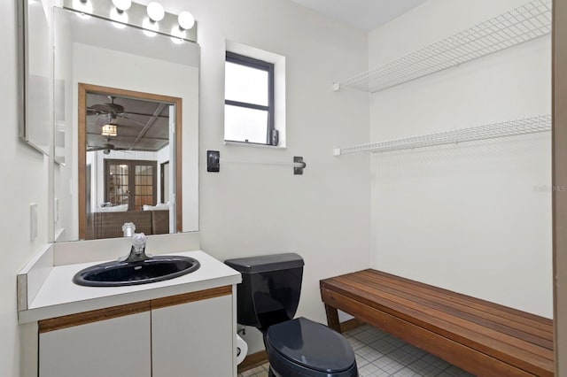 bathroom with a ceiling fan, vanity, and toilet