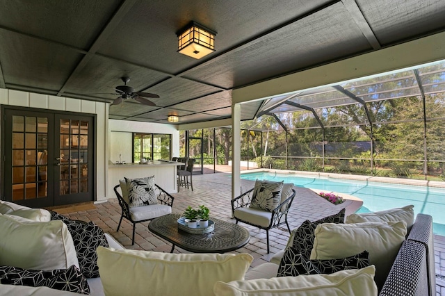 view of patio / terrace featuring an outdoor pool, outdoor dry bar, an outdoor hangout area, a lanai, and french doors