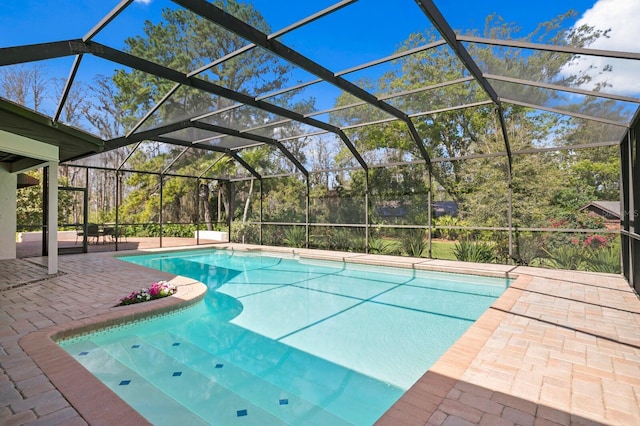 outdoor pool with glass enclosure and a patio area