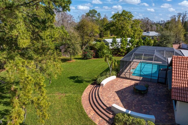 pool featuring a yard, a patio area, and a lanai