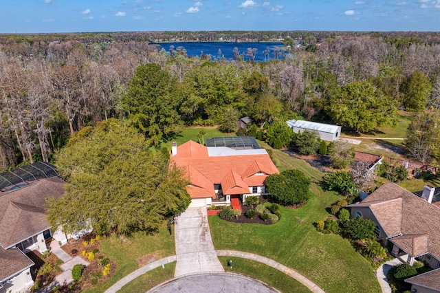 birds eye view of property with a water view and a view of trees