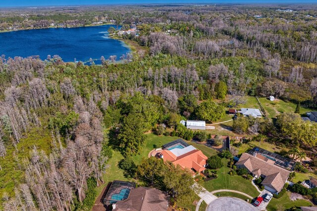 drone / aerial view featuring a water view and a forest view