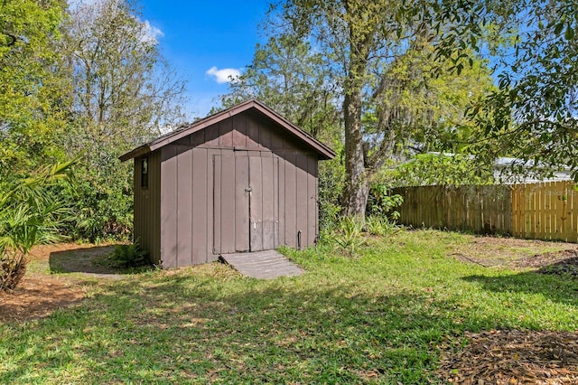 view of shed featuring fence