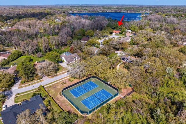 bird's eye view with a water view and a forest view