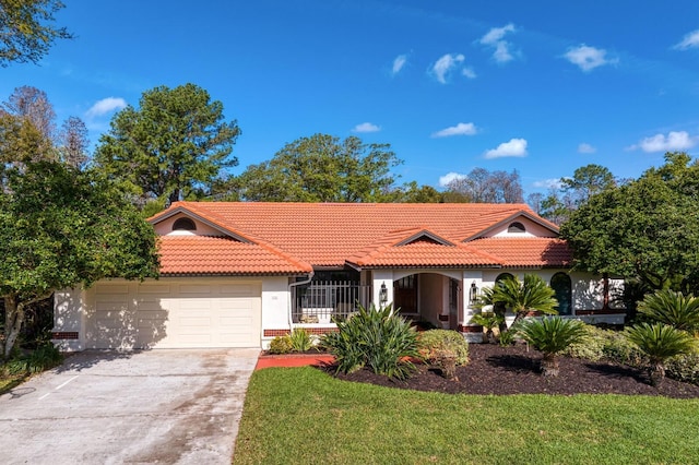 view of front facade with a garage, a tiled roof, concrete driveway, and stucco siding