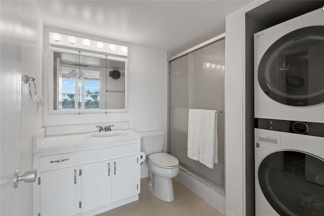 full bath featuring a stall shower, toilet, stacked washer / drying machine, tile patterned flooring, and vanity