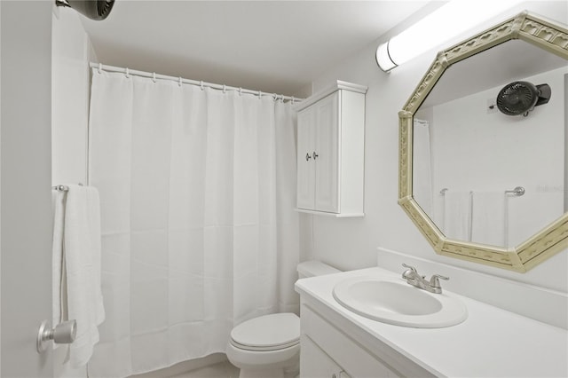 bathroom featuring toilet, curtained shower, and vanity