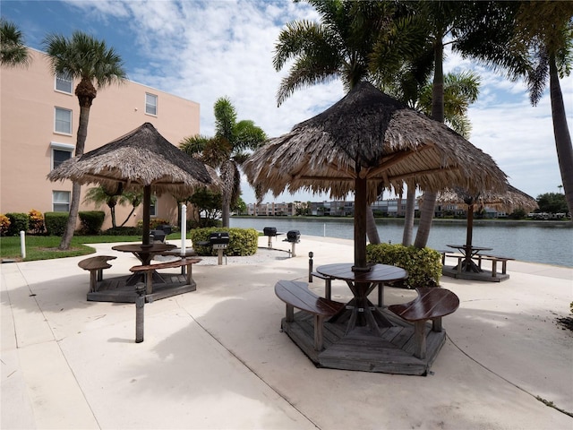 surrounding community featuring a patio and a water view