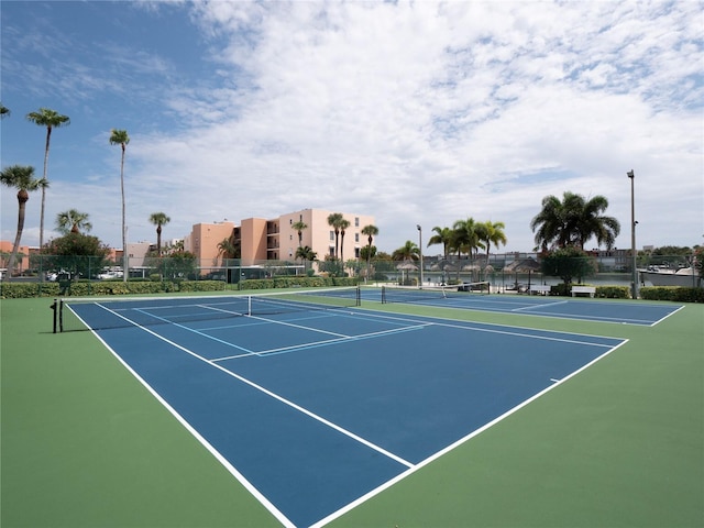 view of tennis court featuring fence