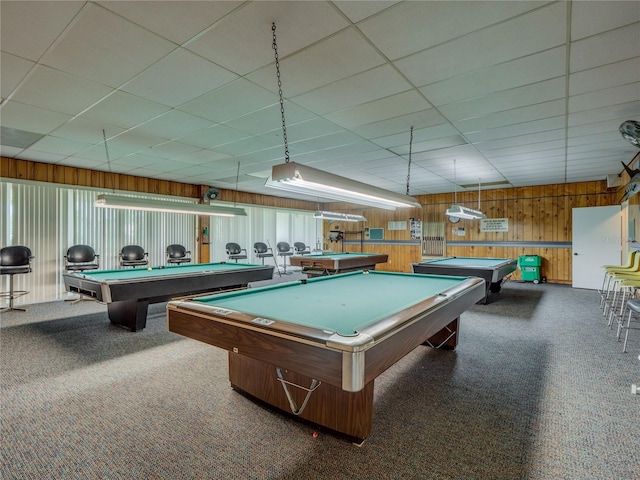 game room with billiards, wooden walls, a drop ceiling, and carpet flooring