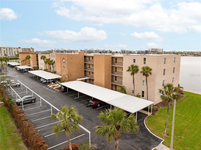 view of property with a view of city and uncovered parking