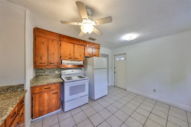 kitchen with white appliances, visible vents, decorative backsplash, under cabinet range hood, and brown cabinets