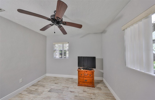 unfurnished bedroom featuring visible vents, a ceiling fan, baseboards, and a textured ceiling