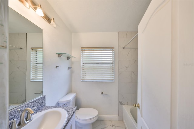 bathroom featuring vanity, toilet, marble finish floor, and a wealth of natural light