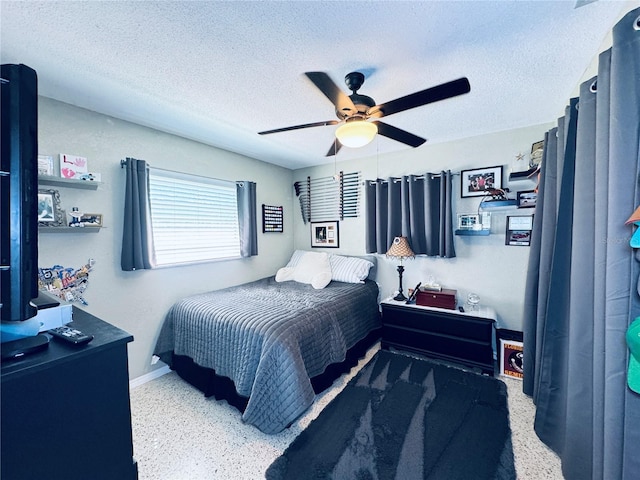 bedroom featuring baseboards, a ceiling fan, a textured ceiling, and speckled floor