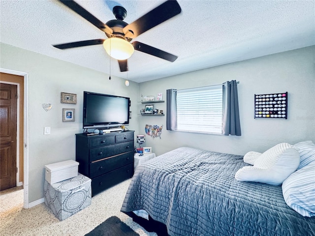 bedroom featuring ceiling fan, baseboards, a textured ceiling, and speckled floor