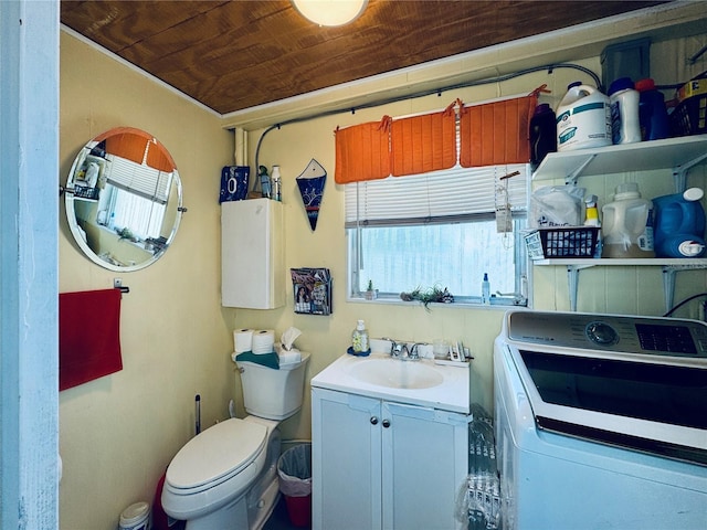 bathroom with toilet, wood ceiling, washer / clothes dryer, and vanity